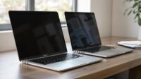 Two MacBook Pros on a wooden desk.